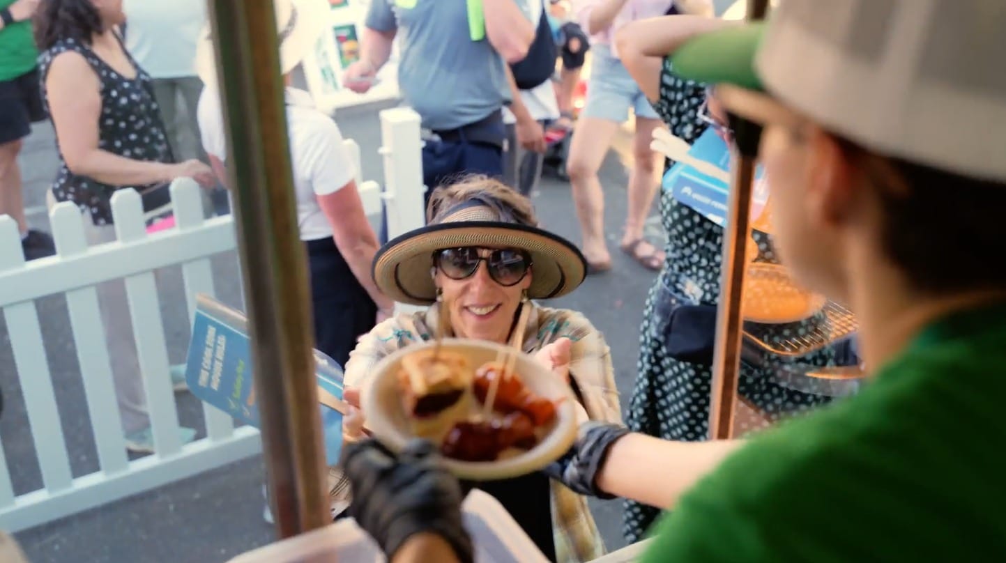 Consumer receiving MorningStar Farms samples from the food truck window