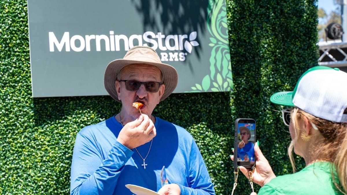 Consumer tasting a MorningStar Farms sample at a branded photo wall